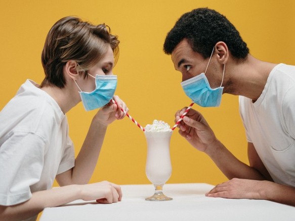 Couple eating together, despite face mask