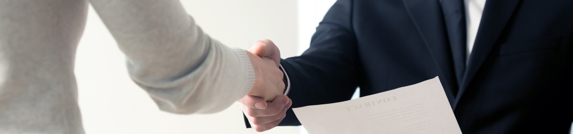 Händedruck beim Vorstellungsgespräch mit Unterlagen 
