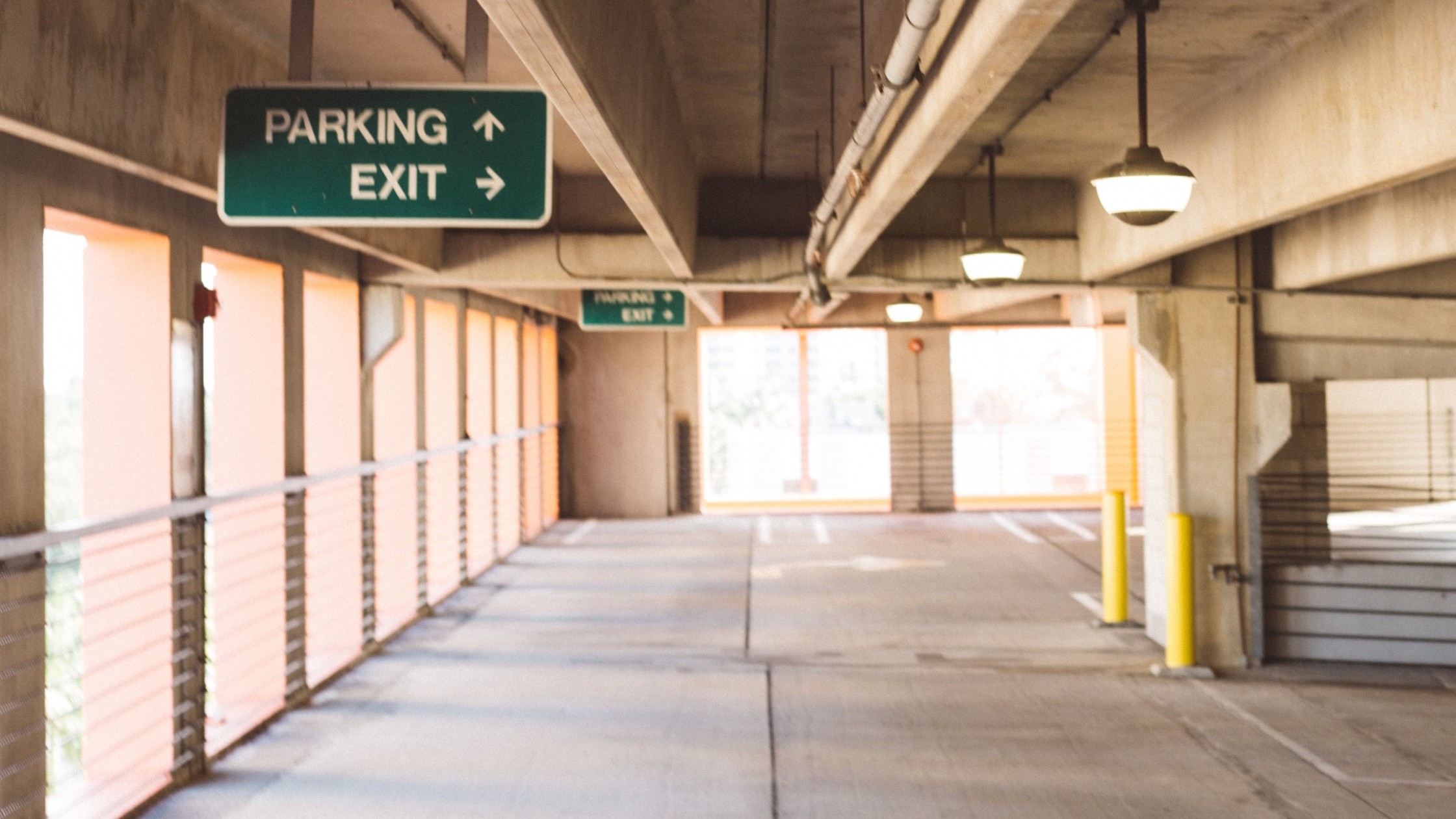 Empty parking garage with direction signs.