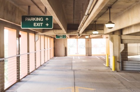 Empty parking garage with direction signs.