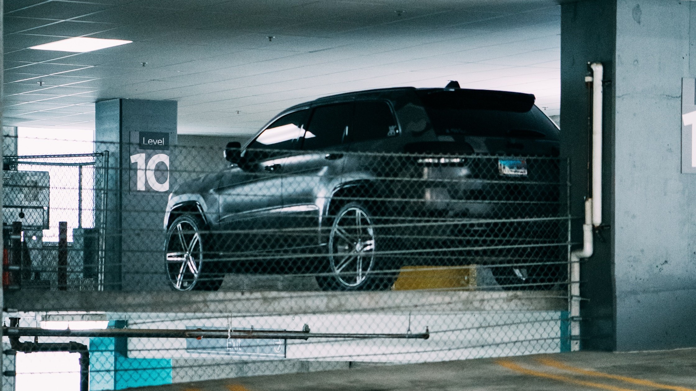 A car parked in a large parking garage