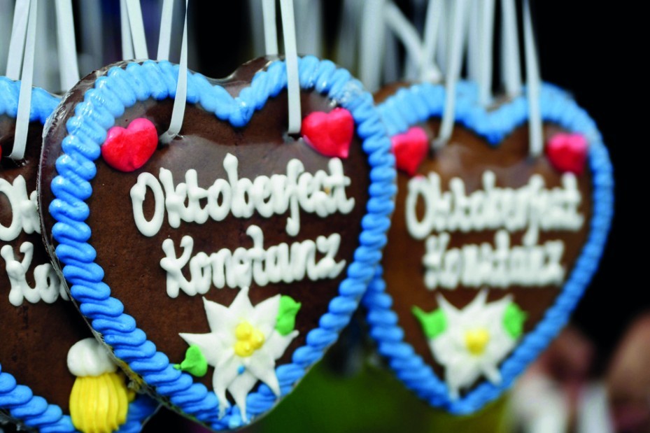 Bunte Lebkuchenherzen mit Aufschriften hängen als Dekoration auf dem Oktoberfest