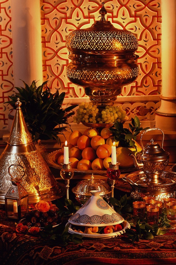 Decorated fruit buffet with candles, tagines and Moroccan receptacles.